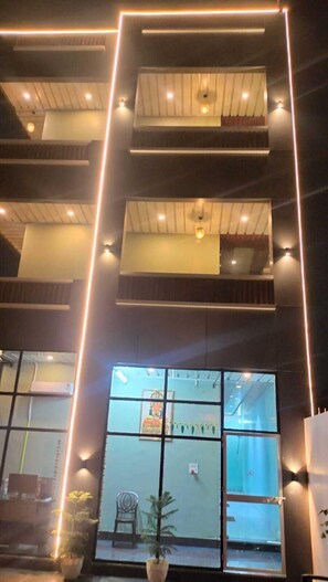 A multi-story building with balconies, large windows, and a modern design. - Radhe Palace (Ayodhya)
