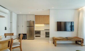 A modern kitchen with a built-in oven, microwave, and refrigerator. -  Apt w/ Barbecue Grill 50 m from the Beach DOI0203 (Florianópolis)