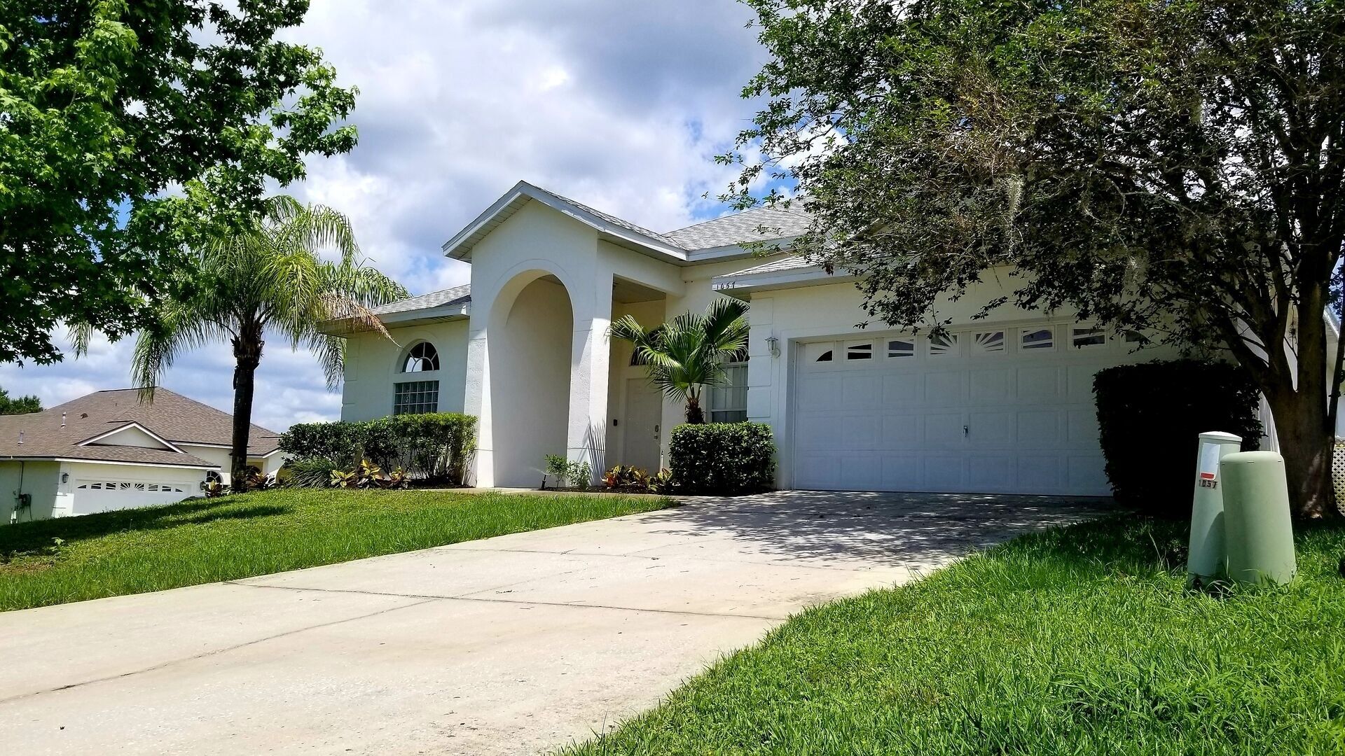 A single-story house with a garage, a front lawn, and a driveway.