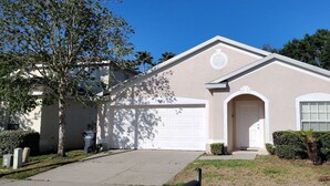A single-story house with a garage, a front door, and a small front yard. - HL740BD 4 Bedroom Villa in Hampton Lakes 4 Home (Davenport)