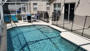 An outdoor swimming pool with lounge chairs and a covered seating area. - HL740BD 4 Bedroom Villa in Hampton Lakes 4 Home (Davenport)