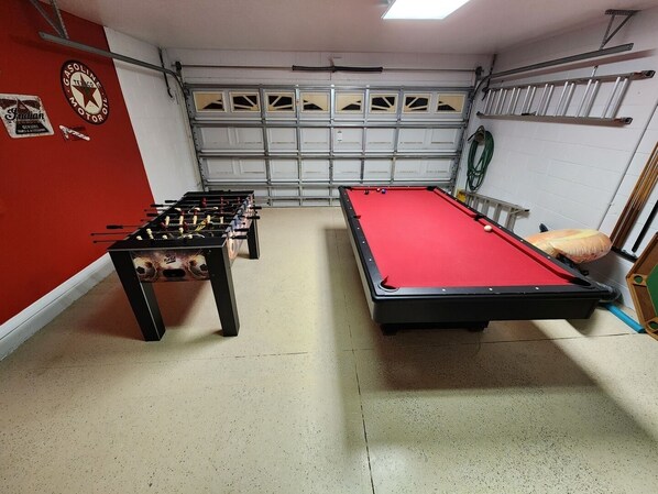 A room with a foosball table, a pool table, and a garage door. - Sol826sc 4bed Solana Private Pool Home 4 Bedroom Home (Davenport)