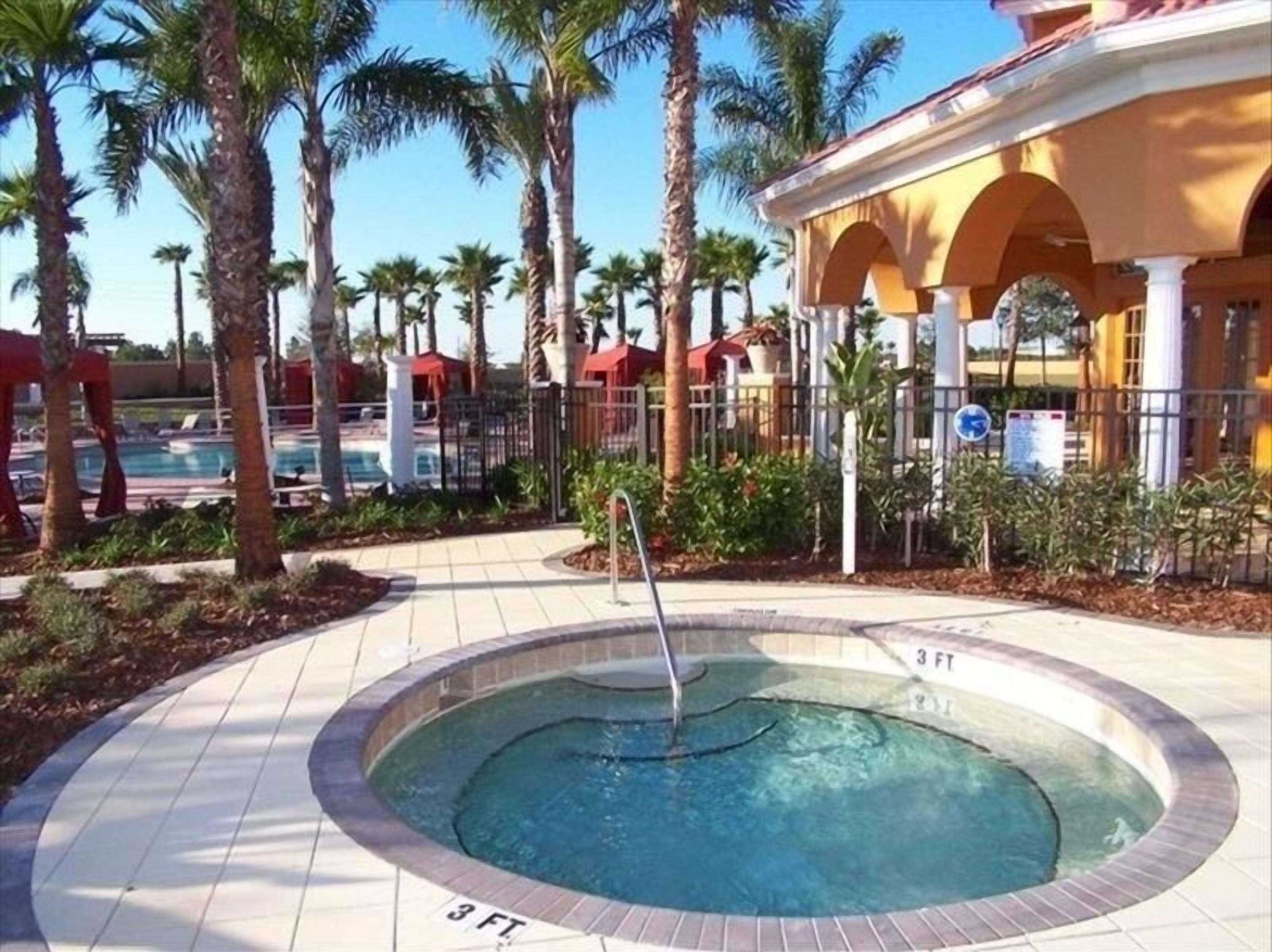 A circular hot tub with a 3 ft depth marker, surrounded by palm trees and a pool area.
