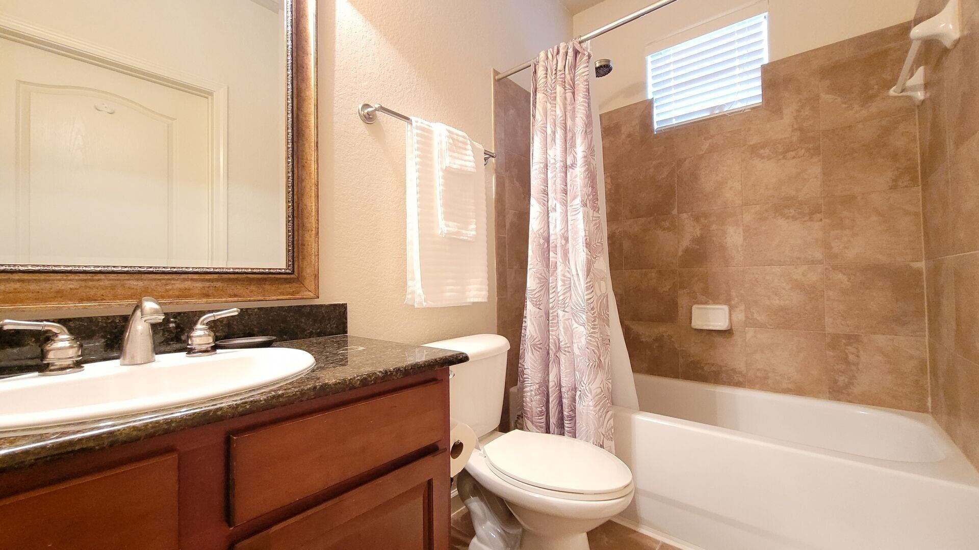 A bathroom with a sink, toilet, and bathtub.