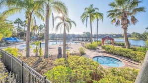 A pool area with palm trees, lounge chairs, and a gazebo. - Av410vd Relax Retreat Villa In Aviana Resort 4 Bedroom Home (Davenport)