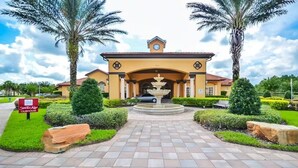 A hotel entrance with a tiled pathway, palm trees, and a fountain. - Ws192tl Watersong 5 Bed Pool Home 5 Bedroom Home (Davenport)