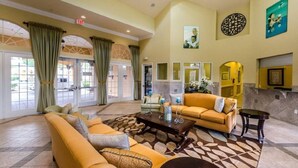 A spacious lobby with a large sofa, a coffee table, and a fireplace. - Ws192tl Watersong 5 Bed Pool Home 5 Bedroom Home (Davenport)