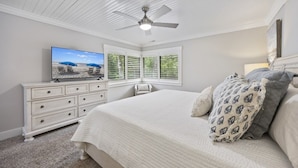 A bedroom with a bed, a dresser, a television, and a ceiling fan. - Harbour Master - Monthly Rates Through 2/28/26! 3 Bedroom Villa (Hilton Head Island)