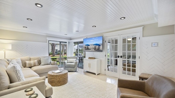 A spacious living room with a sofa, armchairs, a coffee table, and a television. - Harbour Master - Monthly Rates Through 2/28/26! 3 Bedroom Villa (Hilton Head Island)