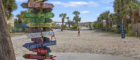 A multi-directional signpost with various destination names and distances.