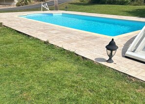 A rectangular swimming pool with a tiled deck, a lamp post, and a grassy area. - Comfortable country gîte in the Pays de Tronçais fishing/walking and cycling (Valigny)