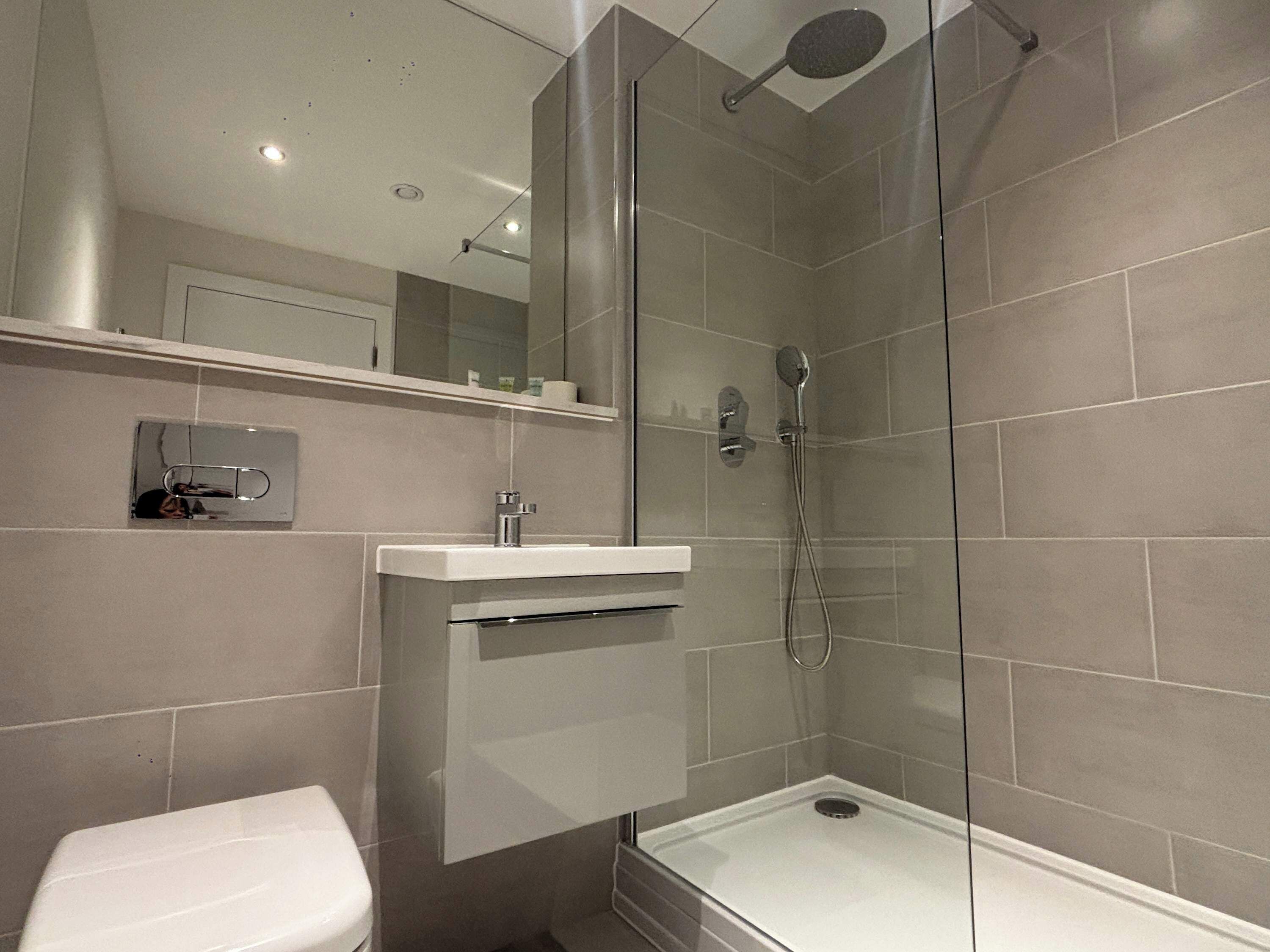 Shower, hair dryer, towels, shampoo