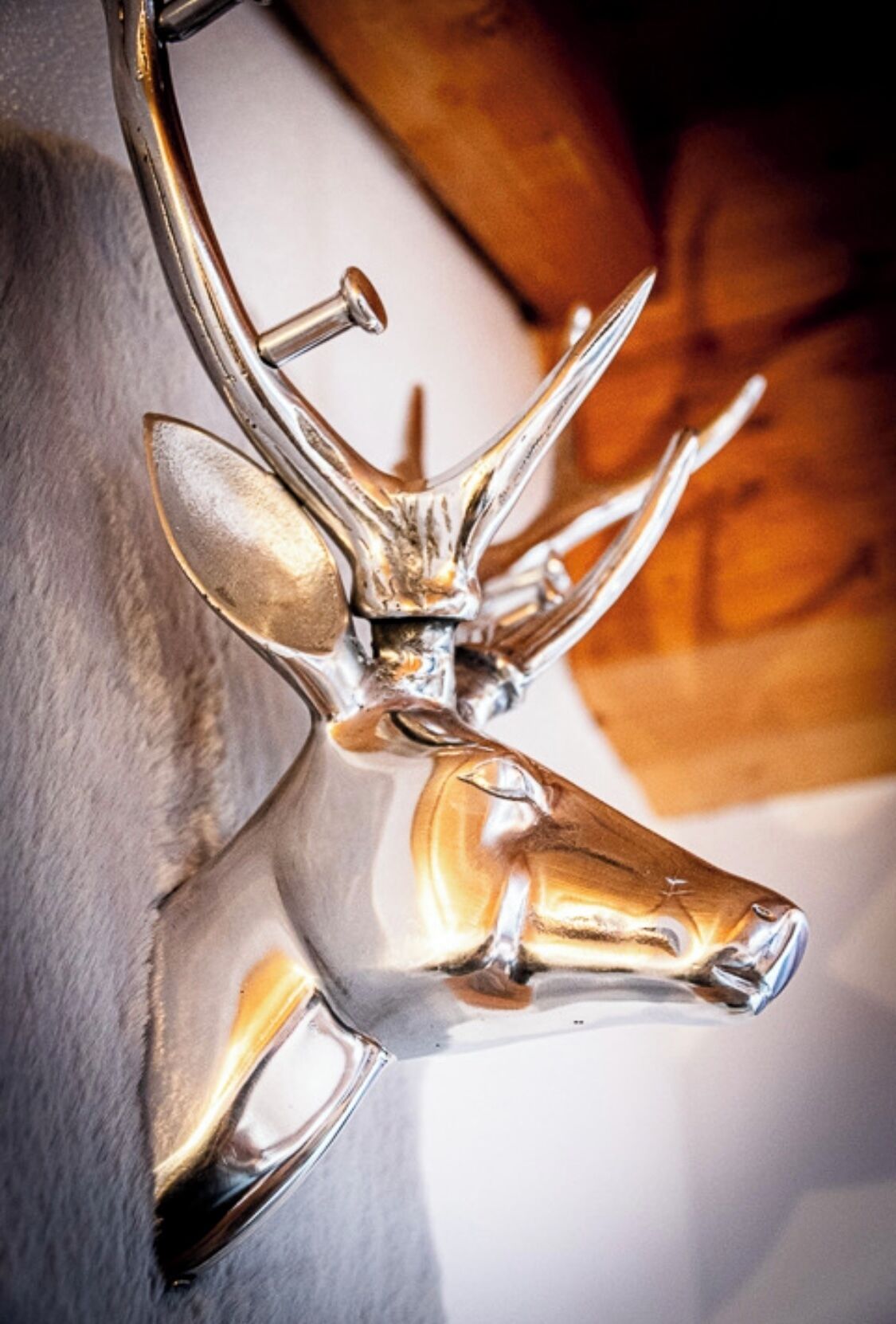 A wall-mounted deer head sculpture.