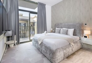 Un dormitorio moderno con una cama grande, una silla, vistas al balcón y una pared de madera.