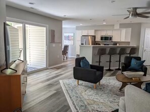 A modern living room with a sofa, a coffee table, and a rug.