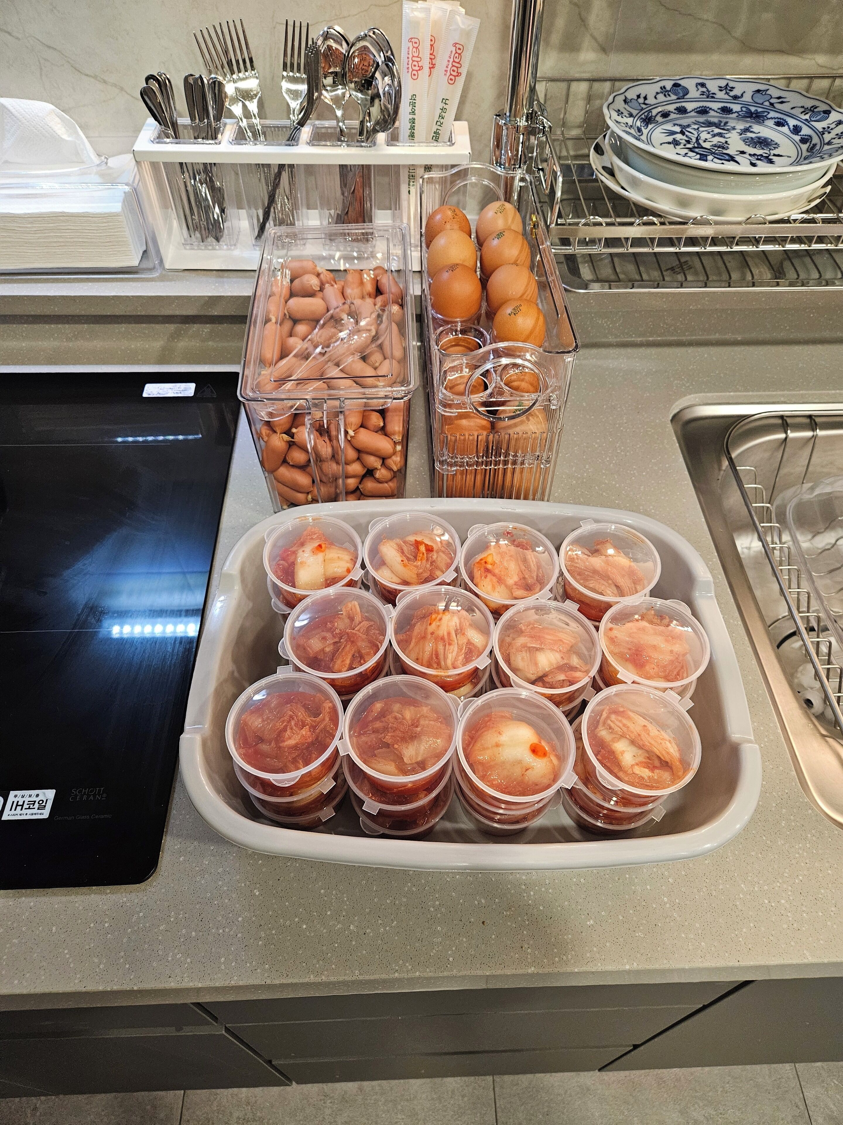 A kitchen counter with various food items and utensils.