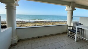 A covered balcony with a view of the beach and ocean. - Palacio Del Mar 307 - Rocky Point Oceanfront Vacation Rental (Puerto Peñasco)