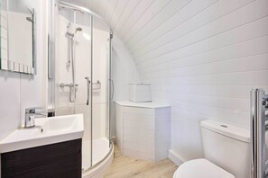 A modern bathroom with a shower, toilet, and vanity. - Host & Stay | Secret Garden (Beccles)