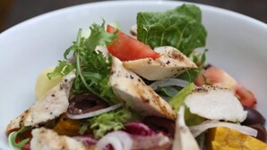 A bowl of salad with various vegetables and grilled chicken pieces. - Relaxing 1-bedroom resort with AC in peaceful Preah Sihanouk #4 (Preah Sihanouk,)