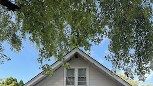 A single-story house with a gabled roof, a front porch with a staircase, and a brick foundation. - Delightful 2-bedroom fully remodeled house with AC in charming Oshkosh (Oshkosh)