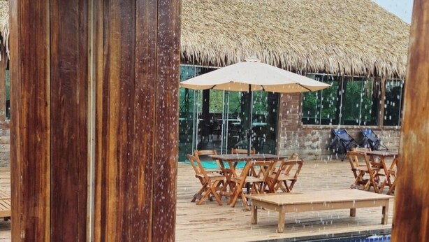 A wooden deck with a pool and lounge chairs. - Amazon tucuna ecologico  (Careiro)