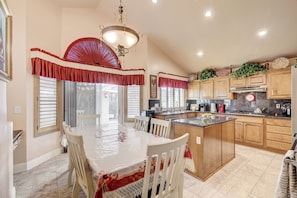 A kitchen with a central island, wooden cabinets, and a chandelier. - Luxury,5 Bed rooms,private pool /Spa Near Strip &Airport,15 %/25% Special offer! (Las Vegas)