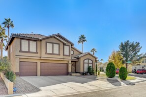 A two-story house with a garage, a front porch, and a driveway. - Luxury,5 Bed rooms,private pool /Spa Near Strip &Airport,15 %/25% Special offer! (Las Vegas)