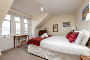 A bedroom with a bed, a window, a table, and a lamp. - Burnside, The Toft | Elie (Elie)