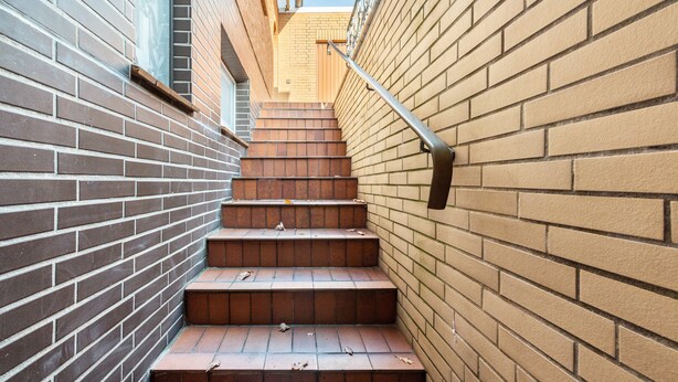 A set of outdoor brick stairs leading up to a building entrance. - Apartment "Souterrain" with Private Terrace, Garden, and Wi-Fi (Cuxhaven)