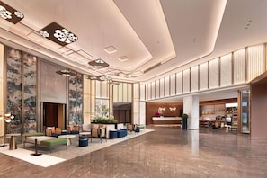 A spacious lobby with seating areas, a reception desk, and a modern ceiling design. - Hilton Garden Inn Chongqing Bishan (Chongqing)