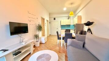 Deluxe Apartment, Balcony, City View | Living area | 42-inch LCD TV with cable channels