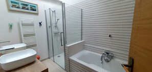 A modern bathroom with a glass-enclosed shower, a bathtub, and a white sink. - A beautifully restored Perigordian barn with a large swimming pool (Saint-Paul-Lizonne)