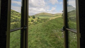 An open window with a view of a green valley and hills. - Howgill Head (Kendal)