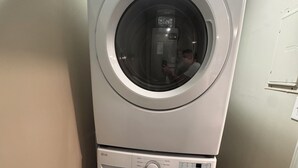 A stacked washer and dryer unit with control panels and a door. - Quaint 2-bedroom apartment Historic downtown Florence (Florence)