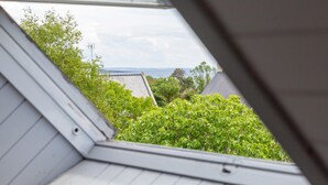 A skylight view of a residential area with houses and trees. - Ty Annick – Port Manech Room (Névez)