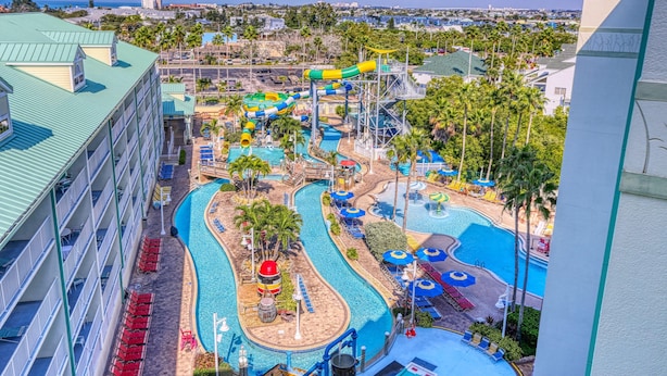 A water park with multiple slides and pools, surrounded by hotel buildings. - Harbourside 8816 (Indian Rocks Beach)