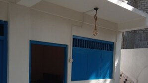 A building with a white exterior, blue accents, a visible staircase, and a hanging light fixture. -  Amaya Hotel and Restaurant (Dikwella)