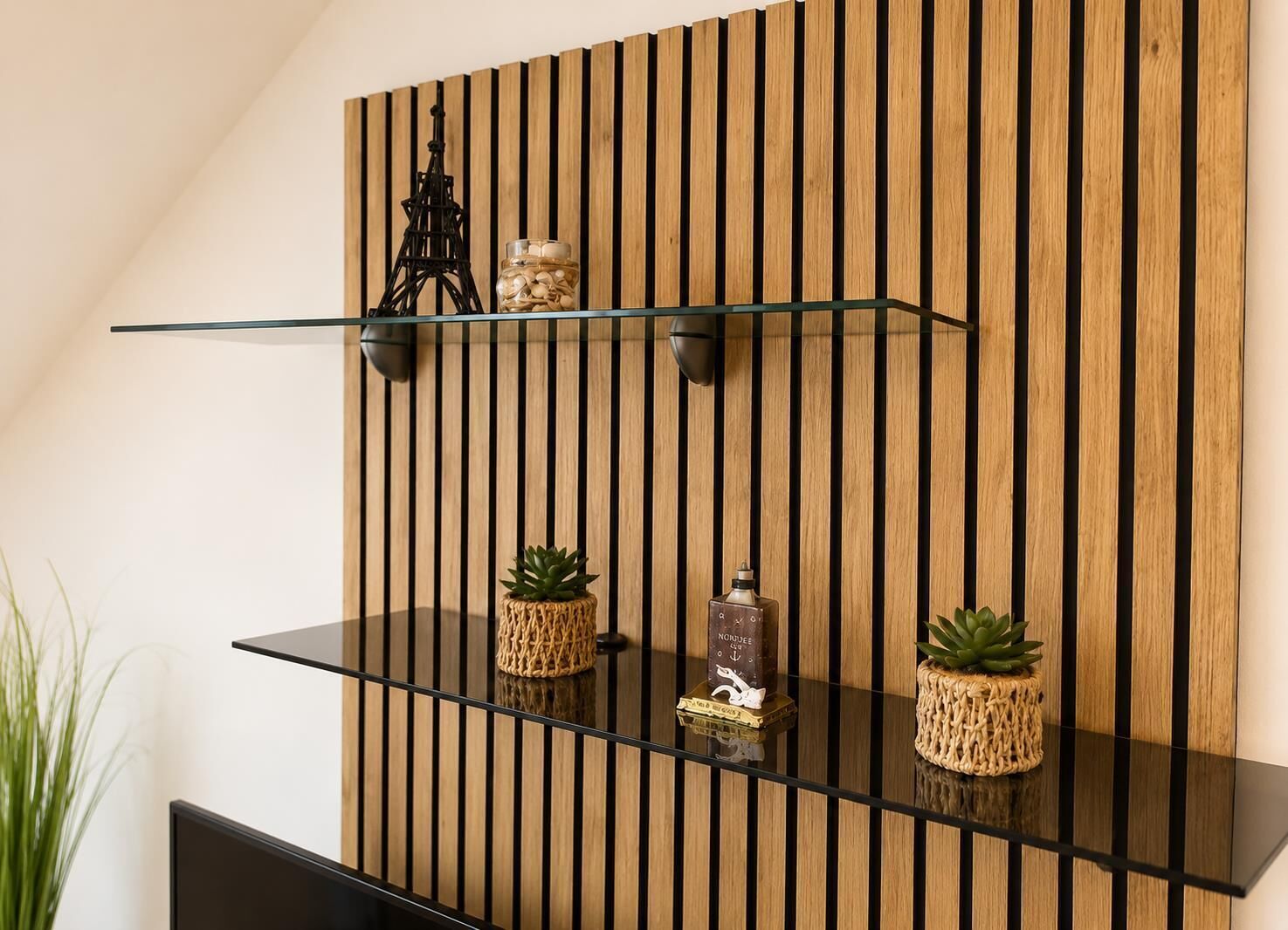 A modern interior with a wooden slat wall, glass shelves, and decorative items.