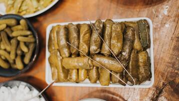 A plate of stuffed grape leaves on a wooden table.