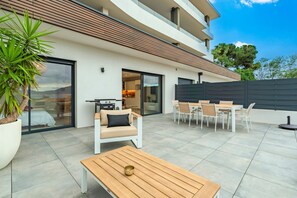 A modern outdoor patio with a dining area, a sofa, and a table. - A Terrazzo di Calypso - Grande Terrasse (Grosseto-Prugna)