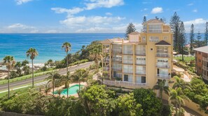 A multi-story hotel with balconies, a swimming pool, and a view of the ocean. - Orion 3 - Beachfront Rainbow Bay Coolangatta Luxury - Linen Provided - Min. 3 Night Stays (Coolangatta)