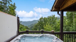 A hot tub on a wooden deck with a scenic mountain view. - Falcon’s Nest-Spacious w/Spectacular Views!Hot Tub (Maggie Valley)