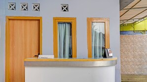 A reception desk with a sign that reads "31 ORCHID VILLA." - OYO 95060 Ahzafani Homestay Syariah (Lemahireng)