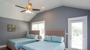 A bedroom with two beds, a ceiling fan, and a window with blinds. - Spacious Nashville Family Home| Perfect for Groups (Nashville)