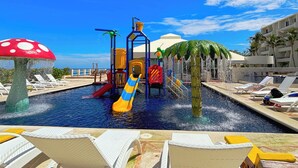 A water park with slides and a pool area, surrounded by lounge chairs and palm trees. - Cozy Studio apartment in tranquil Cancún with AC (Cancún)