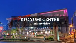 A KFC Yum! Center with a modern glass facade and illuminated signage. - King Bed| Pet Friendly |2BR Townhome with Parking (Louisville)