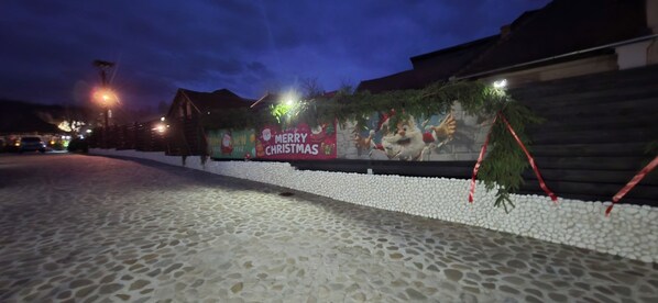 A building facade with a 'Merry Christmas' sign and festive decorations.