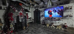 A cozy room with a large TV, a Christmas tree, and various decorations. - Discover the Charm of AGI Traditional
Experience the essence of Romanian culture (Bran)