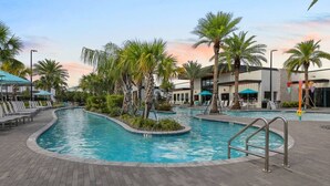 A swimming pool area with lounge chairs and palm trees. - Paradiso Grande 5BR Home w Pool, Mario Game Room (Orlando)