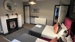 A hotel room with two beds, a fireplace, a mirror, and a ceiling light. - garden flat in vibrant area of Clifton  by Bristol university (Bristol)